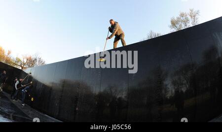 Washington, USA. 09th Apr, 2017. U.S. Secretary of the Interior Ryan Zinke helps volunteers from the Rolling Thunder motorcycle advocacy group clean the Vietnam Veterans Memorial Wall April 9, 2017 in Washington, DC. Credit: Planetpix/Alamy Live News Stock Photo