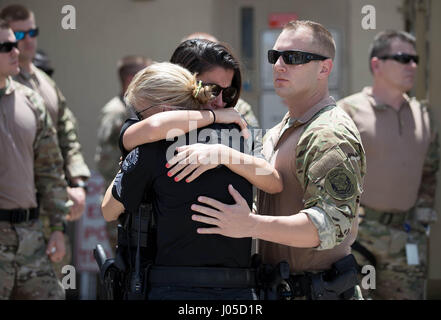 April 10, 2017 - Delray Beach, Florida, U.S. - Fellow officers hug Delray Beach Police Officer Stephanie Kearney (dark hair, dark glasses) after a press conference remembering Officer Christine Braswell, 40, who was killed in a scooter accident while off duty on vacation in Key West. Fellow officer Bernenda Marc, 25, was flown to Jackson Memorial South in Miami where she is recovering from critical injuries. (Credit Image: © Allen Eyestone/The Palm Beach Post via ZUMA Wire) Stock Photo