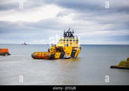 Aberdeen, Scotland, UK. 11th Apr, 2017. UK Weather. Cloudy overcast with light rain and gales expected as Njord Viking a TUG SUPPLY VESSEL leaves Aberdeen harbour for the north sea oilrigs. The Njord Viking  Offshore Supply Ship is a High Ice-classed AHTS vessel capable of operations in harsh environment offshore regions, as well as Arctic/Sub-Arctic operations. Credit: MediaWorldImages/Alamy Live News Stock Photo