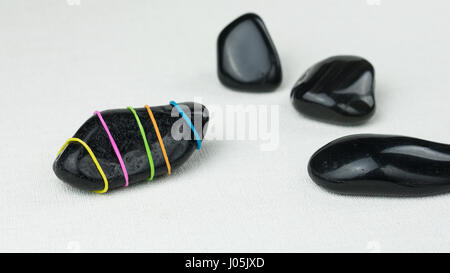 Being different, stand out of a crowd conceptual, shown on stone sample striped in different colours Stock Photo