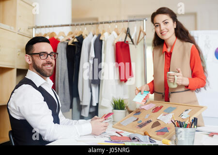 Team of contemporary fashion designers working in studio Stock Photo