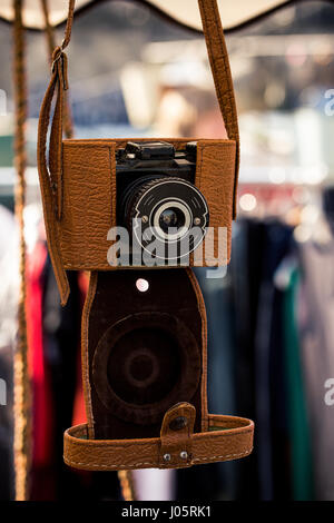 Old vintage analog camera in a light brown leather case. Stock Photo