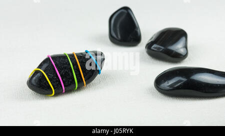 Being different, stand out of a crowd conceptual, shown on stone sample striped in different colours Stock Photo