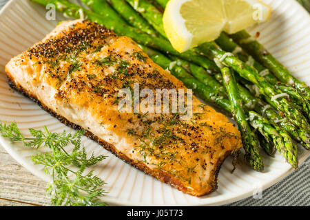 Organic Pan Seared Salmon with Lemon and Asparagus Stock Photo