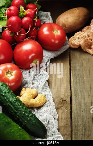 Frame made from fresh vegetables on wooden rustic table. Top view, space for text. Stock Photo