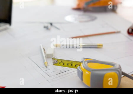 Blueprints, Hardhat, Glasses, Stickers, Construction level, Pen in architecture office. Stock Photo