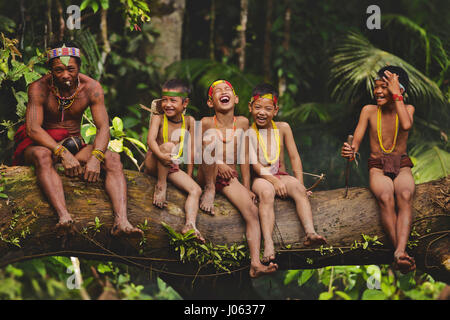 SIBERUT ISLAND, INDONESIA: MAGNIFICENT photographs of the last members of a tattooed tribe give an insight into their daily lives on the isolated island they call home. The Mentawai Tribe live a basic and traditional lifestyle away from the technology of the 21st Century. The photographs show the tribe hunting in vast tropical jungle and captured personal moments as a father handed down tribal traditions to his son. These people are the last to use their tribal technique of hand-tapping to tattoo their bodies. They inhabit Siberut Island in Indonesia and were intimately photographed by Henry K Stock Photo