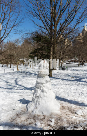 Snowman standing in central park, New York Stock Photo