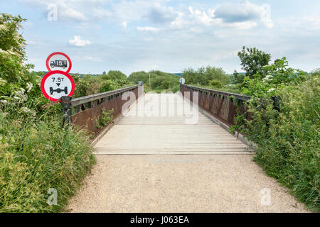 Steel framed road bridge with wooden surface, and road sign showing vehicle weight limit and axle weight restriction, Nottinghamshire, England, UK. Stock Photo