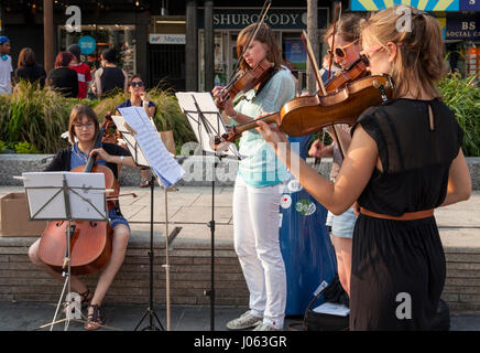 Buskers: Young women musicians busking classical string quartet music, Nottingham, England, UK Stock Photo