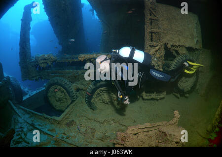 A diver swimming over to a truck. EERIE underwater pictures show inside the wreckage of the sunken British World War Two ship SS Thistlegorm on the seventy-fifth anniversary of her sinking. The series of images show the rusted remains of the merchant navy ship’s cargo which includes motorbikes, army trucks and an aircraft propeller. Other pictures show how sea life have been inhabiting the wreckage. Stock Photo