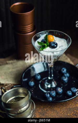 Healthy yogurt with blueberries, strawberries and cereals. Dessert. The restaurant or cafe atmosphere. Vintage Stock Photo