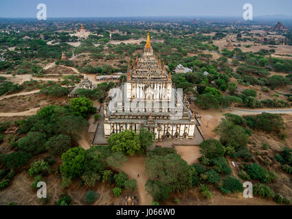 BAGAN, MYANMAR: Thatbyinnyu Temple  is a famous temple located in Bagan, built in the mid-12th century during the reign of King Alaungsithu. It is shaped like a cross, but is not symmetrical. The temple has two primary storeys, with the seated Buddha image located on the second storey. AMAZING aerial drone pictures from three hundred and twenty feet in the air have been captured by an amateur photographer. Pictures and video footage shows the ancient temples around Burma, now known as Myanmar, from above. Showcasing their elegance and dominance over the landscape.  Indian engineer Pradeep Raja Stock Photo