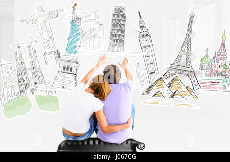 Couple planning their trip around the world and picking places to visit sitting on travel case Stock Photo