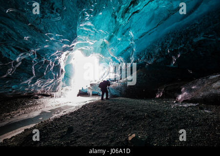 ICELAND: SPECTACULAR images have revealed brave people exploring inside beautiful ice caves despite the melting ice. The series of stunning pictures show tourists climbing on the glossy formed ice, taking photographs and bravely standing underneath sharp looking icicles. Other shots show the frosty blue hues of the lakes that have formed inside the glaciers. In stark contrast, stunning aerial footage shows the expanse of Iceland’s glaciers from the sky, showing the undulating mountain range with snow and ice forming. The incredible shots were captured by Johann Helgason from Hafnarfjordur, Ice Stock Photo
