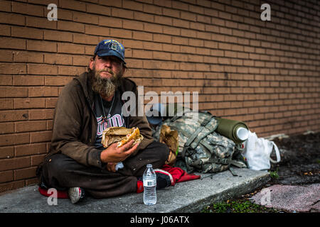 Northern Florida. HEART-WRENCHING pictures show military veterans struggling to get by living on the streets after serving their country. The touching photos show the homeless veterans of wars including Iraq, Afghanistan and even Vietnam begging on the streets, accepting donations from strangers and tucking into a welcome meal. Some cling to the past and still wear their old military clothing while others display signs indication their service history to passers-by. The powerful shots were taken in Washington DC, northern Florida and Atlanta by American photographer Jeff Hagerman (35) from Atl Stock Photo