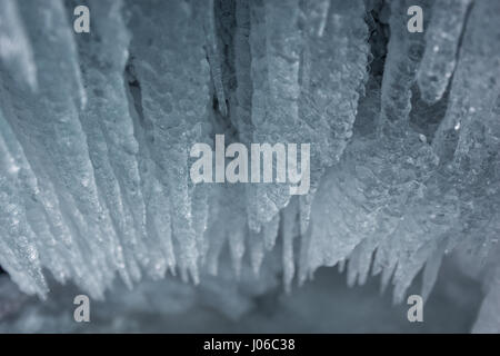 ALBERTA, CANADA: STUNNING images showing women having fun inside sparkling frozen Canadian waterfalls have been revealed by one British expat who lives there. The series of shots show the women sitting directly below giant icicles and walking through what looks like a maze of icicles that touch the frozen ground. Other shots show people taking pictures and admiring the glistening ice formations. One super fun shot shows a woman sliding down an icy slope on her bottom with her arms out wide. The spectacular photographs were taken at Icefields Parkway, near Banff in Alberta, Canada by photograph Stock Photo