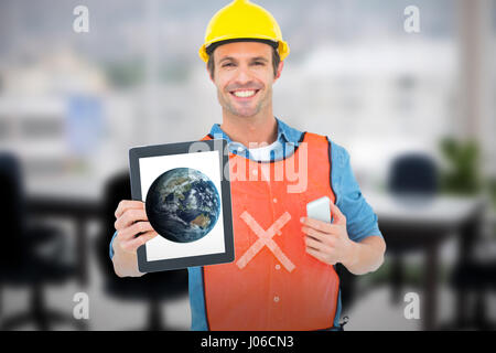 Carpenter holding digital tablet and mobile phone against computer graphic image of empty board room Stock Photo