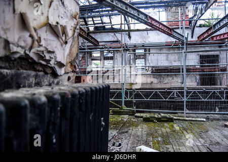 BISHOP AUCKLAND, UK: TAKE a look inside the cracking, crumbling remains of the grammar school once attended by Stan Laurel, one half of the famous comedy duo Laurel and Hardy. Haunting photos show the rotting remains of the derelict King James I Grammar School in Bishop Auckland which Laurel attended for three years from 1902. The eerie images show missing ceilings, wrecked walls, peeling paint and wallpaper and crumbling fireplaces of the school which opened in 1864 and suffered a decade ago. The pictures were taken by urban exploration group WildBoyz who wanted to walk the same corridors as  Stock Photo