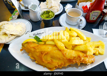 Excellent fish and chips at Colman's famous fish restaurant in South Shields founded in 1926, with a bread roll mushy peas and a cup of tea Stock Photo