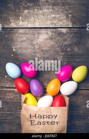 Easter bunny in a paper bag on old boards Stock Photo