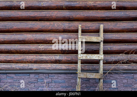 Neutral background wall of round logs of ropes and a lading textured staircase Stock Photo