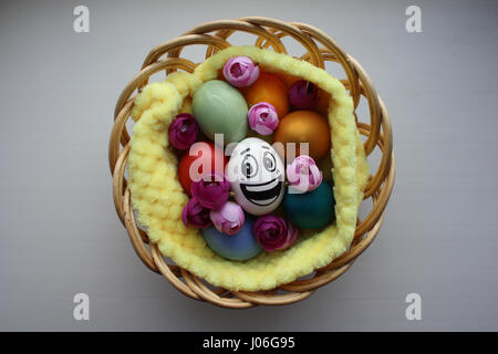 Eggs with a cute face. Photo for your design. Egg with a big smile among the painted Easter eggs Stock Photo
