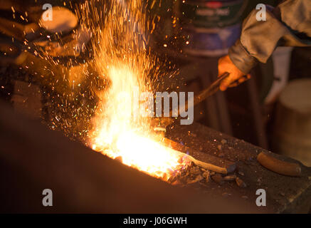 Making of horseshoe. Hot horseshoe in forge. Stock Photo