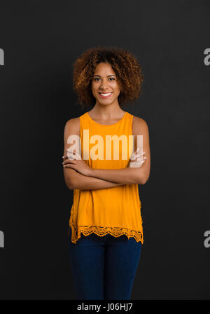 Beautiful African American woman standing with hands folded Stock Photo