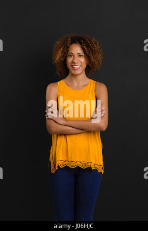 Beautiful African American woman standing with hands folded Stock Photo