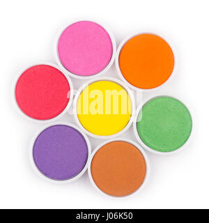 top view closeup of water color palette in white plastic containers isolated on white arranged in flower shape Stock Photo