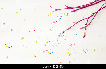 Red tree branch with colorful sprinkles background Stock Photo