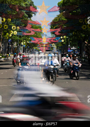 Vertical view of people riding mopeds in Vietnam. Stock Photo