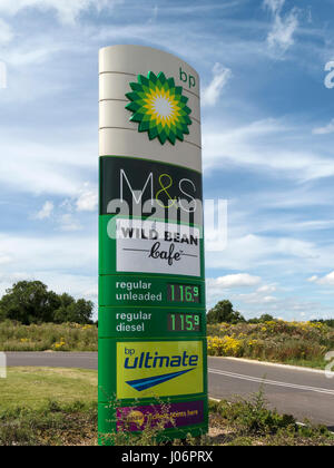 BP M&S Simply Food garage forecourt sign with fuel price display and blue sky behind, Oakham, Rutland, England, UK Stock Photo