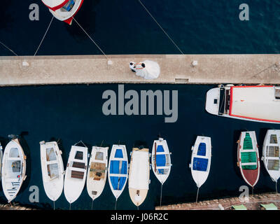 Marina for yachts aerial photography. Newlyweds on the boat dock. Wedding in Montenegro. Stock Photo