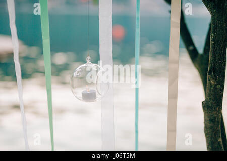 Candles in glass lamps. Wedding decorations. Wedding in Montenegro. Stock Photo