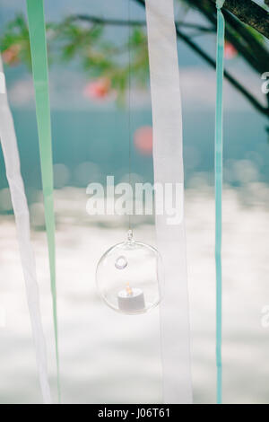 Candles in glass lamps. Wedding decorations. Wedding in Montenegro. Stock Photo