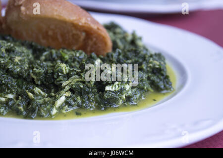 White dish with stew prepared for eating Stock Photo