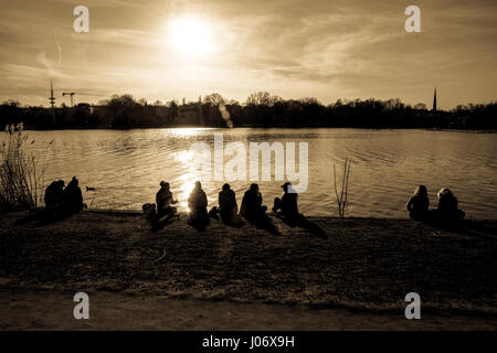 people sitting near the lake Stock Photo