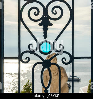 Statue through a window at waterfront, Sant'Angelo, Ischia Island, Campania, Italy Stock Photo