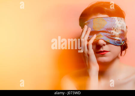 Portrait of a woman with covered eyes in rays of light. Technique mixed light Stock Photo