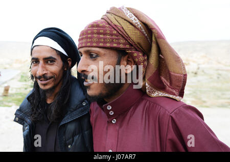 Young Bedouin men wearing a traditional eyeliner called Kohel. Stock Photo