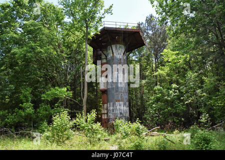 A watch tower. VIRGINIA, USA: HAUNTING pictures and video show the abandoned WW2 US military base where nearly one and a half million personnel passed through on their way to the Western Front. The eerie images and vertigo inducing video show the dilapidated remains of Camp Patrick Henry in a forest in Warwick County, Virginia which could once host up to 35,000 men at one time when it acted as a troop staging ground. The shots show how the decommissioned base has been attacked by vandals with graffiti all over the buildings. Video from the point of view of a brave explorer shows him scaling on Stock Photo