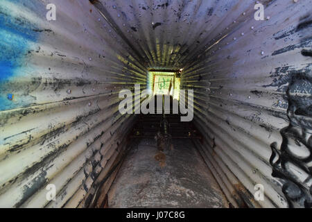 Looknig up a watch tower shaft. VIRGINIA, USA: HAUNTING pictures and video show the abandoned WW2 US military base where nearly one and a half million personnel passed through on their way to the Western Front. The eerie images and vertigo inducing video show the dilapidated remains of Camp Patrick Henry in a forest in Warwick County, Virginia which could once host up to 35,000 men at one time when it acted as a troop staging ground. The shots show how the decommissioned base has been attacked by vandals with graffiti all over the buildings. Video from the point of view of a brave explorer sho Stock Photo