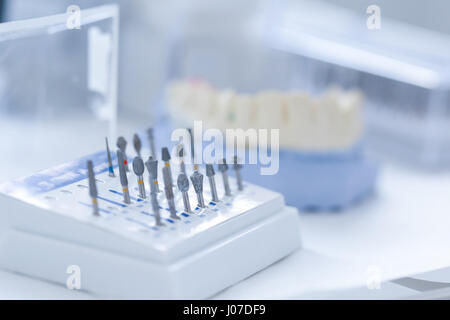 Variety of tools: ceramic preparation kit with dental mold in the background Stock Photo