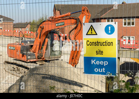 Signage on a perimeter fence surrounding a construction site in the UK Stock Photo