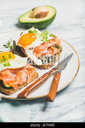 Salmon, avocado, fried egg, sauted green beans and sprouts sandwiches Stock Photo