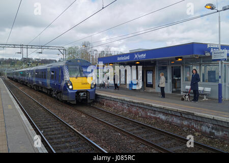 Anniesland railway station train arriving with perspective and passengers Stock Photo