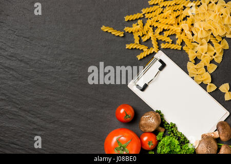 Italian spaghetti photo recipe. Stationary mockup on the kitchen table surrounded with products. Stock Photo
