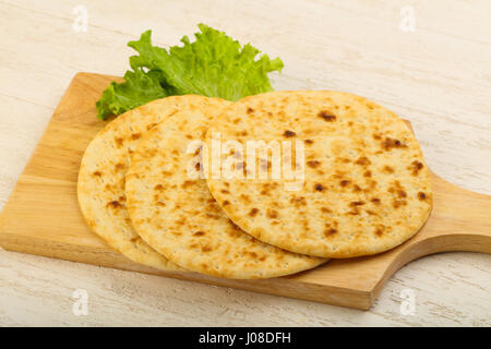 Pita bread with salad over wood background Stock Photo